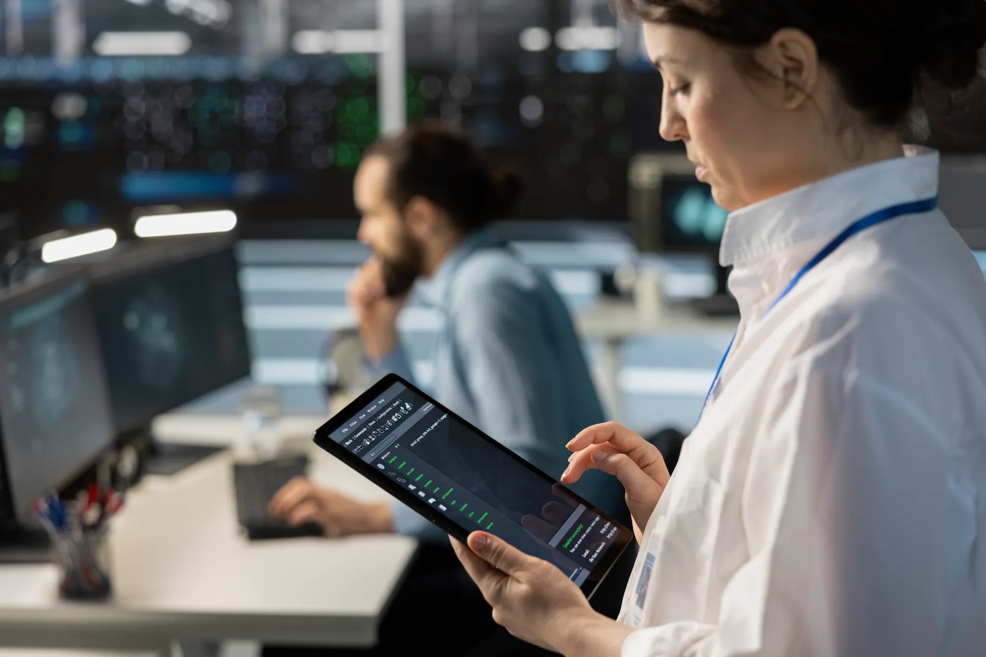 engineer-using-tablet-data-center-managing-servers-running-scripts-closeup